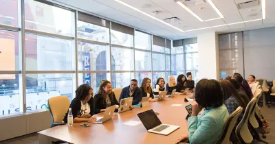 Call center with diverse employees working at computers, engaged in customer support.