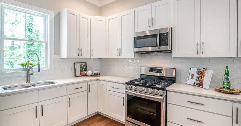 White wooden kitchen cabinet with modern appliances