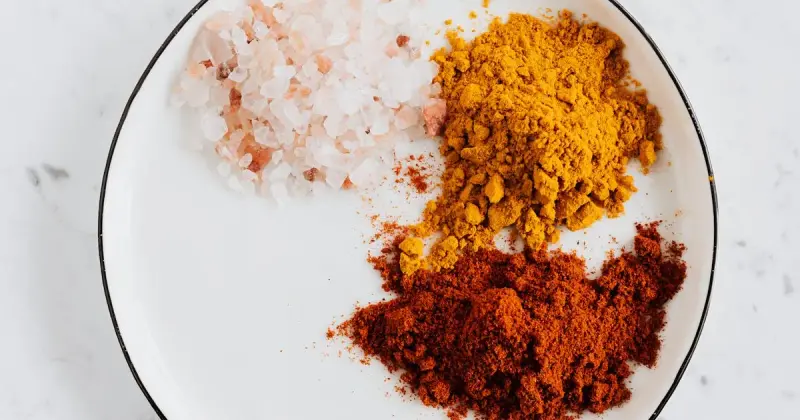 Assorted kitchen spice powders including cream of tartar in bowls