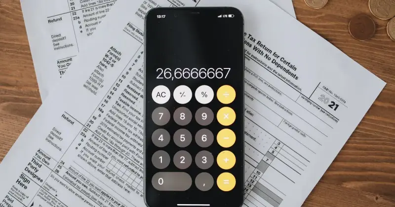 Documents with calculator on wooden surface for planning
