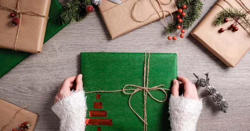 Wrapped presents with ribbons at an organized gift wrapping station