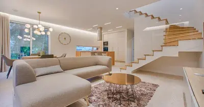 Modern living room with a clean beige sofa and natural light