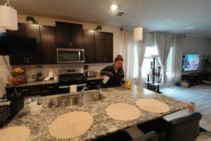 Residential Cleaning 6 House cleaner wiping down granite kitchen counter