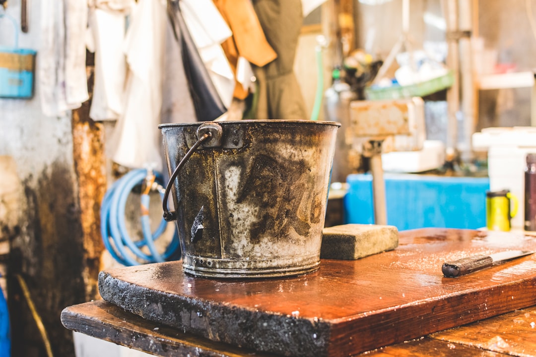 Rusty metal bucket in workshop setting