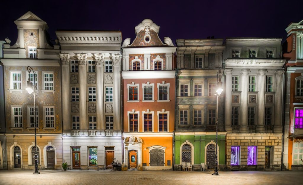 Colorful historical buildings at night in Poznań