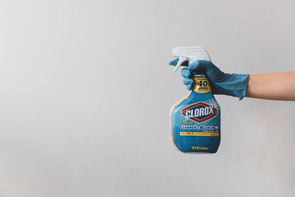 Hand holding Clorox cleaner spray bottle