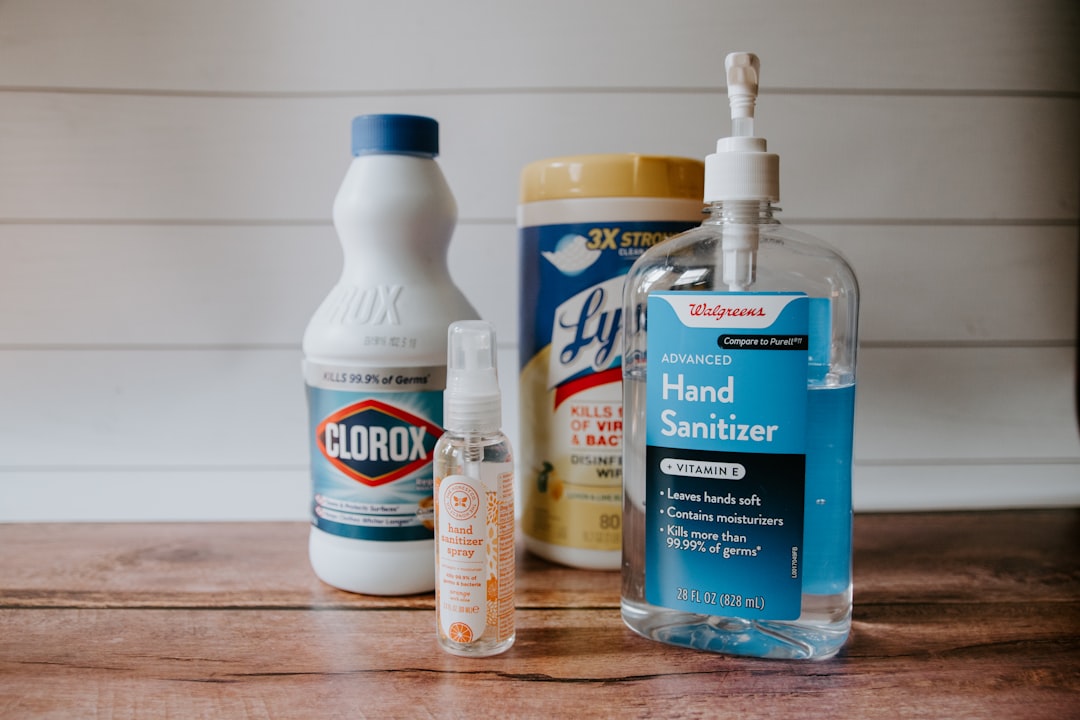 Cleaning and sanitizing products on a wooden surface.