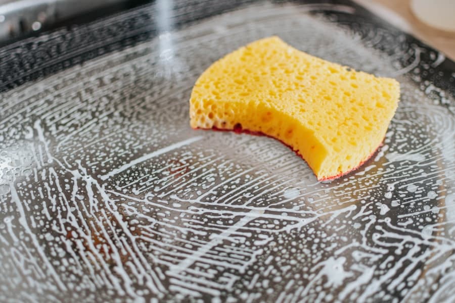 Yellow cleaning sponge on a soapy surface. Professional Airbnb cleaning in Magnolia, TX.