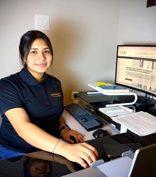 SparkTex Cleaners at her desk, ready to assist with your cleaning needs. Contact us today! Residential and commercial cleaning services in conroe tx and the woodland tx